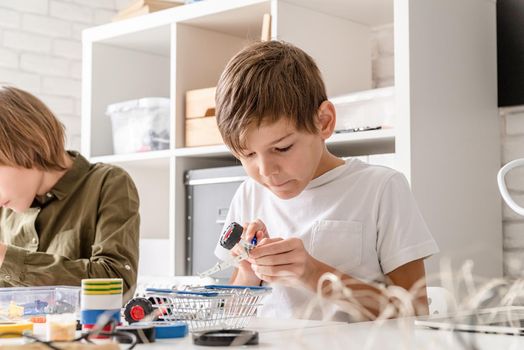 Young boys and having fun constructing robot cars together at the workshop