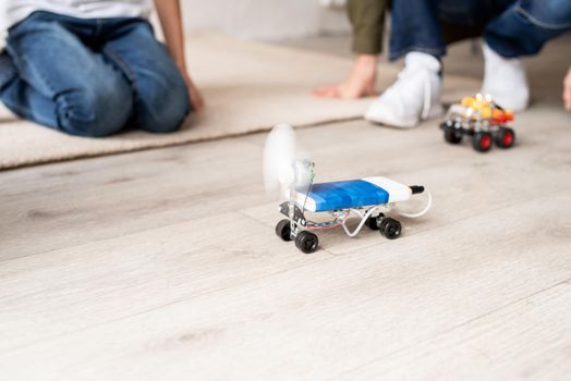 Young boys and having fun constructing robot cars together at the workshop