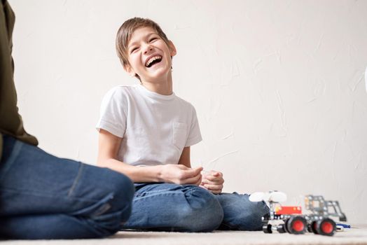 Young boys and having fun constructing robot cars together at the workshop