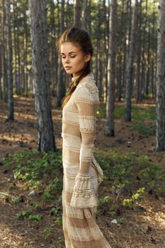 woman portrait in the forest fresh air dress trees. High quality photo