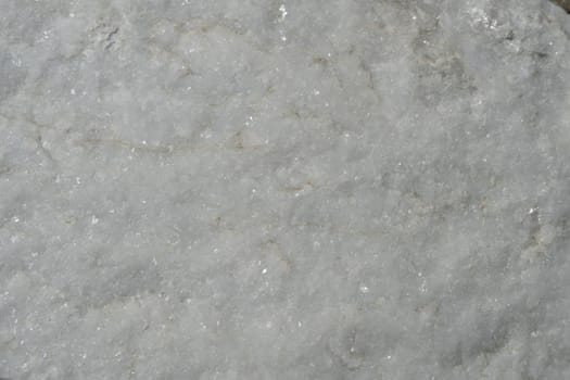 Natural background of light marble with a non-uniform texture.
