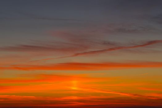 Background with bright orange-red sunset on dark blue sky.
