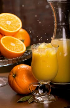 glass of fresh orange juice with fresh fruits on wooden table