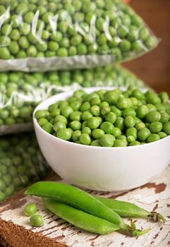 fresh green pea in bowl on wooden background.