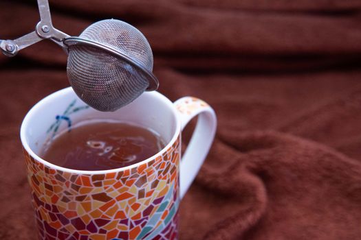 Making a tea in a colorful cup