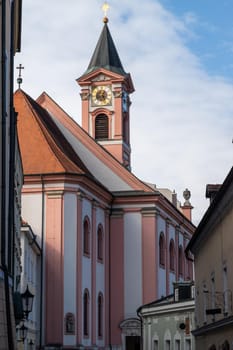 The tower of church Saint Paul in Passau, Bavaria, Germany with green trees in foreground 