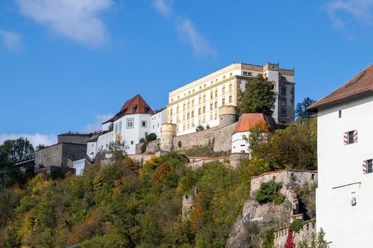 View at fortress Veste Oberhaus in Passau during a ship excursion in autumn with colorfull trees