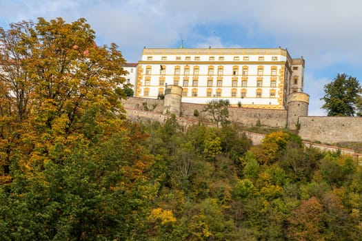 View at fortress Veste Oberhaus and museum in Passau during a ship excursion in autumn with colorfull trees