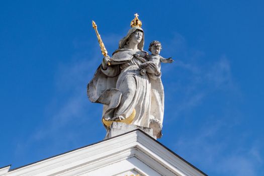 Statue with golden scepter and crown on St. Stephen's Cathedral (Dom St. Stephan) in Passau, Bavaria, Germany on a sunny day in autumn