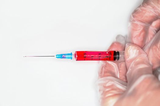 Close-up of a nurse releases air from a syringe with a medicine before injection