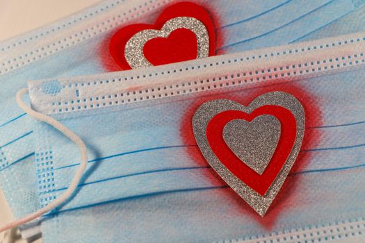 Saint Valentine's day love themed medical facemasks with textured silver and red hearts design