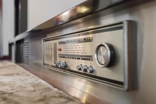 Wood vintage antique analog radio with radio dial. Retro technology.