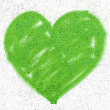 Green heart on grungy wall. Creative spray paint. Ideal for Love and Valentine's Day concepts.