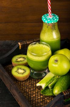 Healthy green smoothie with spinach in a jar mug isolated on white