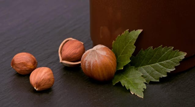 Closeup of hazelnuts, clipping path included on the black wood table