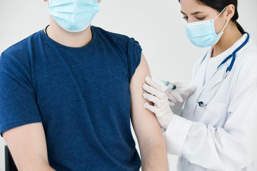 injection epidemic woman doctor nurse wearing protective gloves and coronavirus vaccine. High quality photo