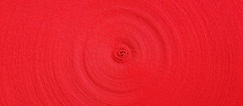 Red abstract circular pattern made of red sling.