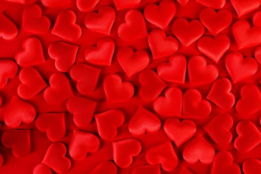 Valentine's day many red silk hearts background, love concept