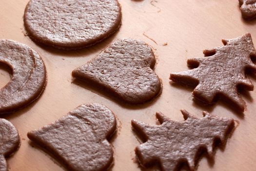 Cutting cookies from the dough and preparing for bake in the electrical stowe