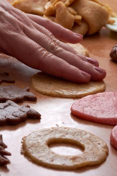 Cutting cookies from the dough and preparing for bake in the electrical stowe