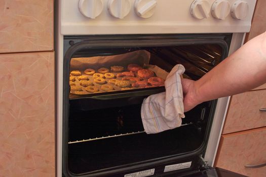 Cutting cookies from the dough and preparing for bake in the electrical stowe