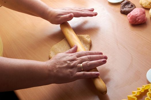 Cutting cookies from the dough and preparing for bake in the electrical stowe