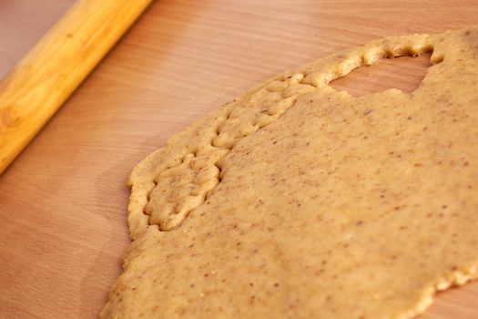 Cutting cookies from the dough and preparing for bake in the electrical stowe