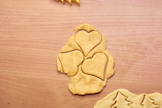 Cutting cookies from the dough and preparing for bake in the electrical stowe