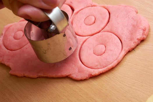 Cutting cookies from the dough and preparing for bake in the electrical stowe