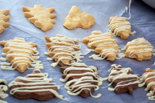 Pouring chocolate on just baked christmas cookies