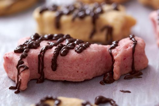 Pouring chocolate on just baked christmas cookies