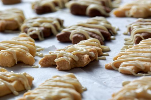 Pouring chocolate on just baked christmas cookies