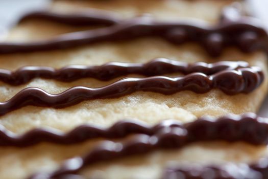 Pouring chocolate on just baked christmas cookies