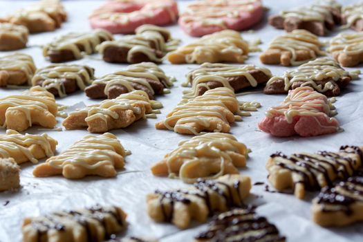 Pouring chocolate on just baked christmas cookies