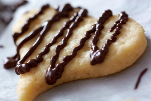 Pouring chocolate on just baked christmas cookies