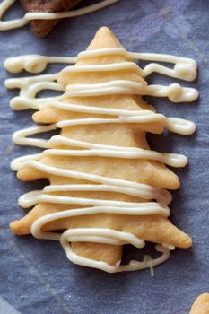 Pouring chocolate on just baked christmas cookies