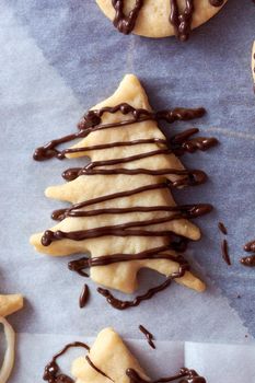 Pouring chocolate on just baked christmas cookies