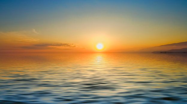 Magnificent bright sunset over the calm surface of the sea. For design and networking.