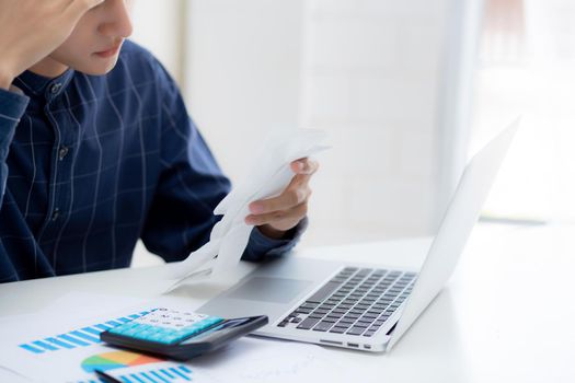 Young asian man calculating expenses household about finance and frustrated on desk at home, male checking bill having stress and worried, debt and tax, expression and emotion, business concept.