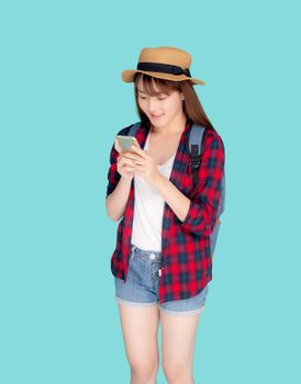 Beautiful young asian woman touch smart mobile phone in vacation isolated on blue background, asia girl talking or chat message on smartphone in travel summer trip, journey or education concept.
