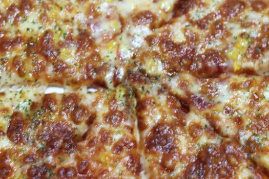 Pizza made with tasty pizza dough, cheese, tomatoes, and green olives. Closeup view of cheese pizza served for dinner