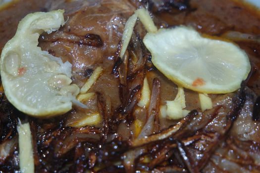 Closeup view of traditional Pakistani Haleem dish with salad and Lemon juice.