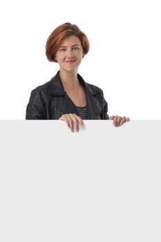 Beautiful redhead casual woman holding blank sign isolated on white background