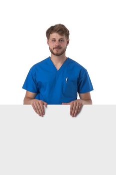 Portrait of a handsome caucasian male doctor nurse with blank banner isolated on white background