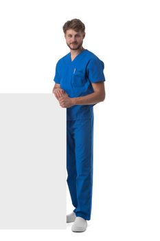 Full length portrait of a handsome caucasian male doctor nurse with blank banner isolated on white background