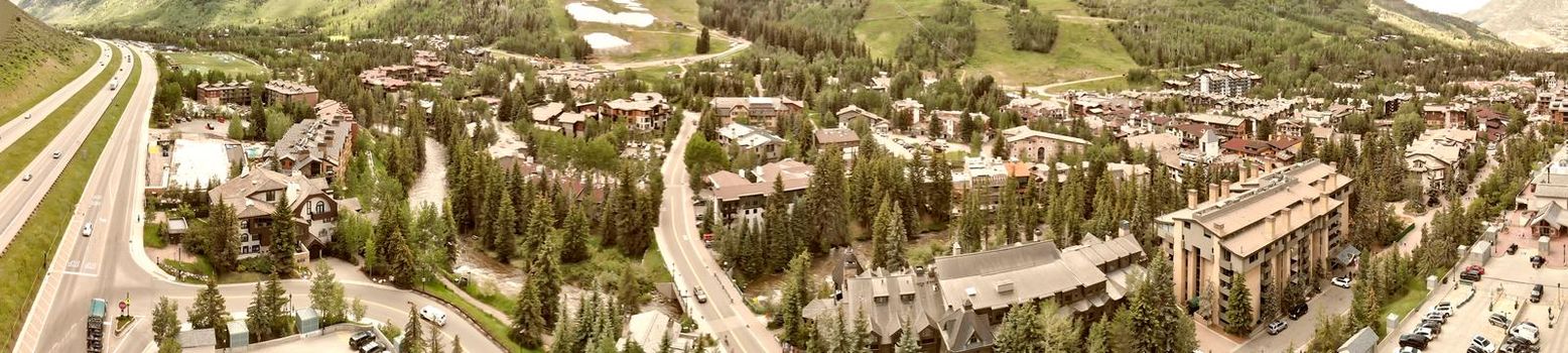 Vail city center and surrounding mountains, Colorado. Aerial view from drone in summer season.