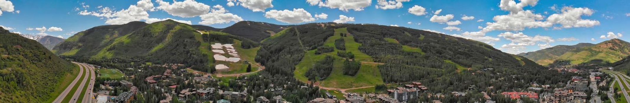 Vail city center and surrounding mountains, Colorado. Aerial view from drone in summer season.