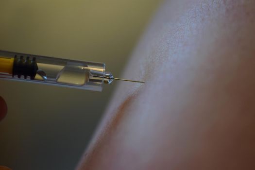 close-up of an injection before injecting it into the arm