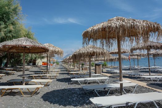 Deserted beach with empty sun beds on the beach. Stock photo