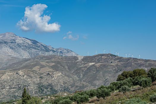 Mountain landscape. Wind generators on top of the mountain. Stock photo